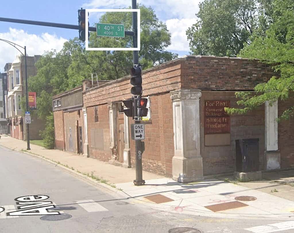 Historic brick building at 40th St and S with traffic light and street sign.